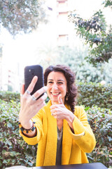 Smiling woman making an outdoor video call