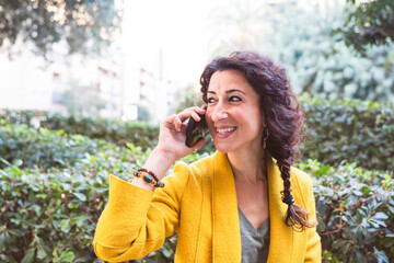 Happy-looking woman calling on the phone outdoors
