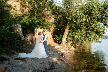 bride blonde girl and groom near the river