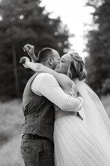 the groom and the bride are walking in the forest