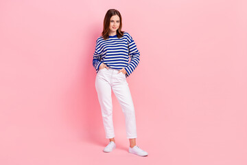 Full body portrait of lovely cute young lady put arms pockets posing isolated on pink color background