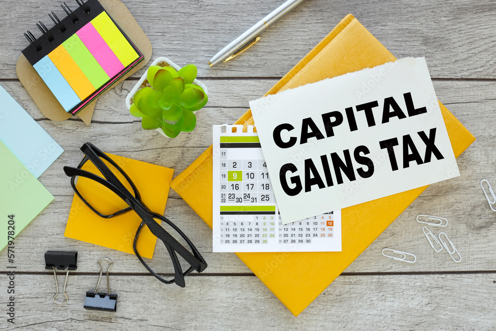 Aufkleber capital gains tax cgt concept. multicolored stickers and yellow notepad with notepad page with text
