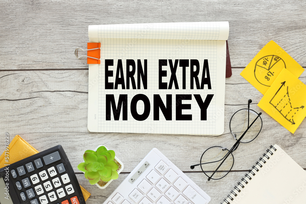 Poster earn extra money. notepad with clip and text near keyboard calculator and glasses