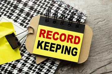 record keeping text on sticker on black paper. business concept. education concept.