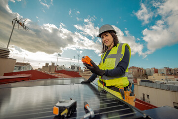 Female electrician engineer using Multimeter on domestic urban Solar Panels