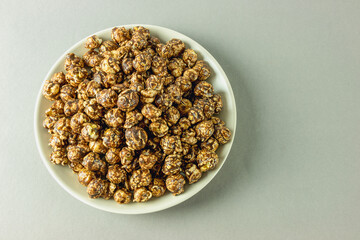 Top view of a bowl of popcorn with caramel and cocoa frosting