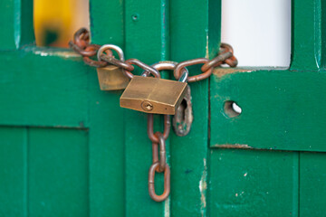 Chain and a padlock closing a door