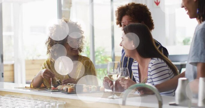 Animation of white spot lights over diverse friends having drink in bar