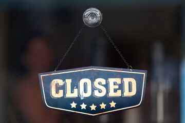 Closed sign in the window of a shop