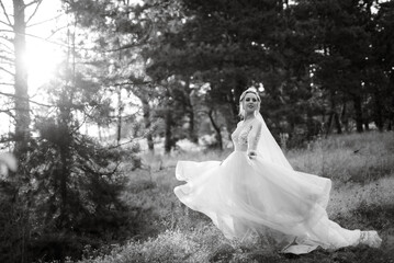 bride blonde girl with a bouquet in the forest