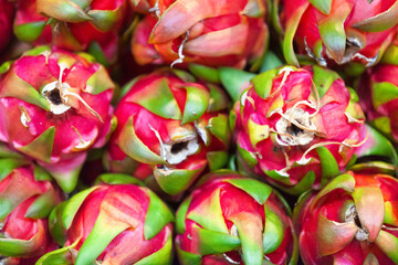 Stack of dragon fruits on a market stall