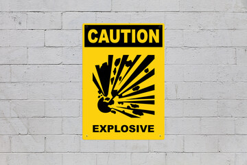 Caution, Explosive sign on a cinder block wall
