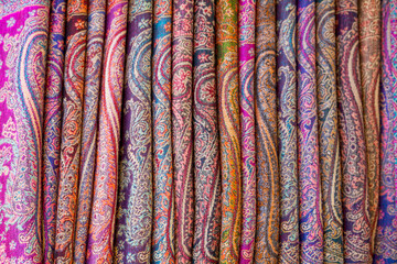 Row of elegant scarves for sale