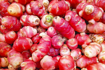 Stack of pink oca on a market stall
