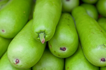 Stack of bottle gourds on a market stall