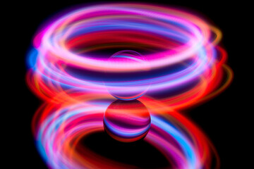 Abstract light painting circling around a glass ball