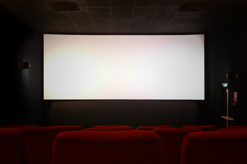 Empty movie theater with blank screen