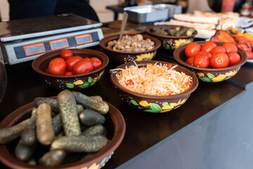 Pickled cucumbers, tomatoes and cabbage in street market ready to eat