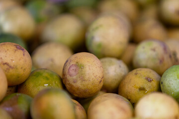 Stack of key limes on a market stall