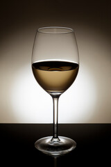 Backlit glass of white wine