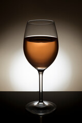 Backlit glass of rose wine