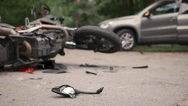 Damaged motorbike and car after accident