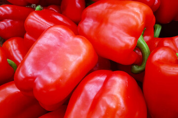 Stack of red bell peppers on a market stall