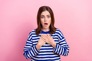 Portrait of shocked young lady hands touch chest open mouth staring cant believe isolated on pink...