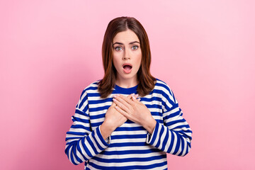 Portrait of shocked young lady hands touch chest open mouth staring cant believe isolated on pink color background