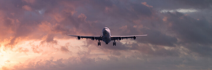 Turbojet airliner landing at sunset