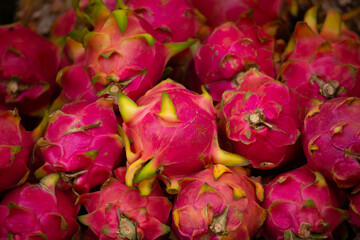 Tropical dragon eye fruit bunch. Pitahaya close-up as a background.