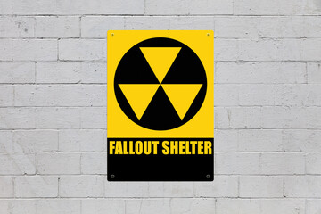 Fallout shelter sign on a cinder block wall