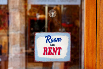 Room for rent sign in a store window