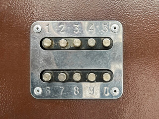 Combination lock on the door of the house. Buttons on the iron door
