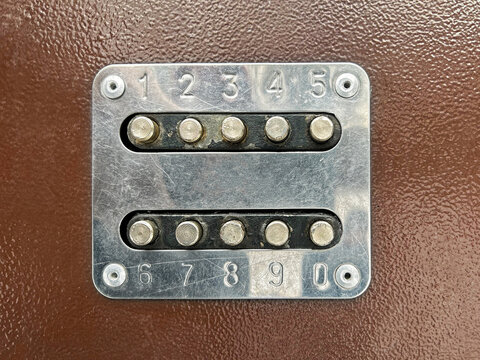 Combination lock on the door of the house. Buttons on the iron door