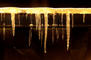 Ice stalactites lite by the street lights