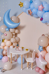 Children's photo zone with a lot of balloons. Decorations for boys and Girls Birthday party. Concept of children's birthday party. Cream-colored and pink balls.