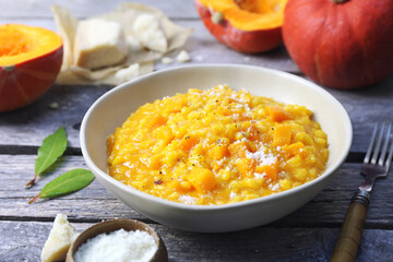 Italian food. Plate of pumpkin risotto and grated parmesan cheese