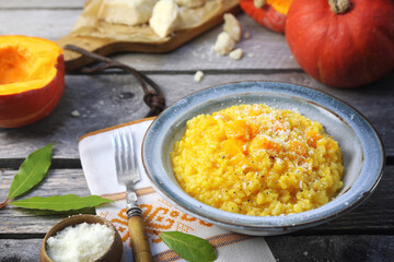 Italian food. Plate of pumpkin risotto and grated parmesan cheese