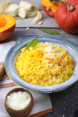 Italian food. Plate of pumpkin risotto and grated parmesan cheese