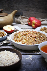 Fresh apple crumble from oatmeal, walnut dressing and cup of tea for healthy breakfast