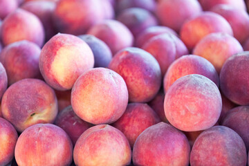 Stack of peaches on a market stall