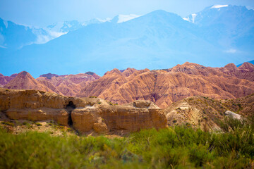 Natural unusual landscape of red rocks against the backdrop of blue mountains. The extraordinary beauty of nature is similar to the Martian landscape. Amazingly beautiful landscape.