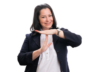 Businesswoman with friendly expression making pause gesture