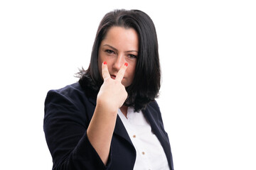 Businesswoman with serious expression making eyes on you gesture
