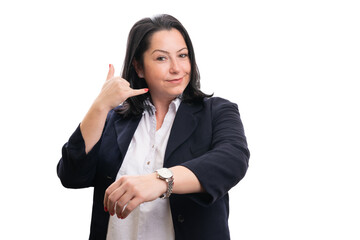 Businesswoman smiling showing wristwatch making call gesture