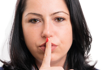 Close-up of businesswoman making quiet gesture with index finger
