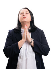 Faithful businesswoman making praying gesture with closed eyes