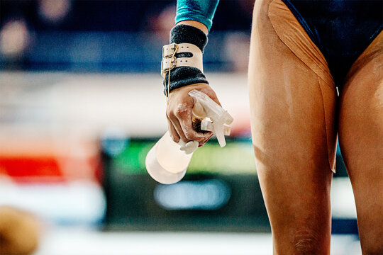 hand girl gymnast in grips chalk gym keep bottle of water