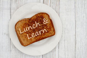 Lunch and Learn message on a plate on wood table